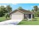 Inviting single-story home features a two-car garage, simple landscaping, and neutral color palette at 2629 Birney Run, Zephyrhills, FL 33541