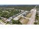 An aerial view of a planned community featuring sidewalks, a park, and green spaces at 2644 Leafwing Ct, Palm Harbor, FL 34683