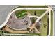 Overhead view of community playground featuring modern play equipment and well-maintained landscaping and walking paths at 2644 Leafwing Ct, Palm Harbor, FL 34683