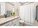Clean bathroom with a shower/tub combo, single sink vanity, and modern fixtures at 2644 Leafwing Ct, Palm Harbor, FL 34683