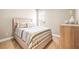 Comfortable bedroom with carpet, a full-size bed, and a light wooden dresser at 2644 Leafwing Ct, Palm Harbor, FL 34683