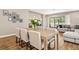 Light-filled dining room with wood floors, dining table and chairs, with a view of the living room at 2644 Leafwing Ct, Palm Harbor, FL 34683