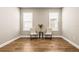 A flex room featuring hard wood floors, neutral paint, and two windows at 2644 Leafwing Ct, Palm Harbor, FL 34683