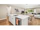 Open concept kitchen with quartz countertop island, stainless steel dishwasher, and hardwood floors at 2644 Leafwing Ct, Palm Harbor, FL 34683