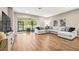 Comfortable living room with a large sectional sofa and sliding glass doors to the outside at 2644 Leafwing Ct, Palm Harbor, FL 34683