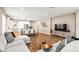 Spacious open-concept living space with wood floors, living room, dining area and kitchen at 2644 Leafwing Ct, Palm Harbor, FL 34683
