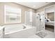 Elegant bathroom with a soaking tub, glass-enclosed shower, and modern fixtures at 2644 Leafwing Ct, Palm Harbor, FL 34683
