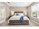 Serene bedroom with large window, plush carpet, ensuite bathroom, and stylish furniture at 2644 Leafwing Ct, Palm Harbor, FL 34683