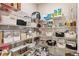 Organized walk-in pantry with wire shelving, filled with food, and other household items at 2644 Leafwing Ct, Palm Harbor, FL 34683