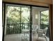 Charming balcony overlooking lush greenery with comfortable wicker seating, ideal for peaceful relaxation at 2737 Enterprise E Rd # 122, Clearwater, FL 33759