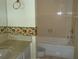 Well-lit bathroom featuring a tub and shower combination and a sunflower-themed decorative border at 2737 Enterprise E Rd # 122, Clearwater, FL 33759