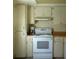 Functional kitchen features a white range, ample cabinet storage, and essential appliances for everyday cooking at 2737 Enterprise E Rd # 122, Clearwater, FL 33759