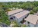 Aerial view of townhouses with well-maintained exteriors, back patios, and lush landscaping at 310 S Delaware Ave # F, Tampa, FL 33606