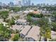 Aerial view shows a townhome complex set among lush greenery, with the city skyline in the background at 310 S Delaware Ave # F, Tampa, FL 33606