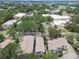 A townhome complex and other buildings sit beneath tall, verdant trees in the aerial view at 310 S Delaware Ave # F, Tampa, FL 33606