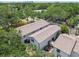 Aerial view of townhouses with well-maintained exteriors, back patios, and lush landscaping at 310 S Delaware Ave # F, Tampa, FL 33606