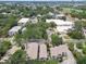The townhome complex, surrounding buildings, and luscious trees in this aerial view have city buildings afar at 310 S Delaware Ave # F, Tampa, FL 33606