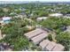 A townhome complex blends with mature trees in an aerial view, with city buildings visible in the distance at 310 S Delaware Ave # F, Tampa, FL 33606