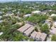 An aerial shot showcases the townhome community and surrounding buildings amidst lush trees, with downtown visible afar at 310 S Delaware Ave # F, Tampa, FL 33606