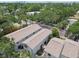 Lush trees cover the aerial view of a townhome complex with city buildings afar at 310 S Delaware Ave # F, Tampa, FL 33606