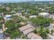 Lush trees surround a townhome complex; city buildings stand out in the aerial view at 310 S Delaware Ave # F, Tampa, FL 33606