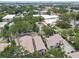 The townhomes and nearby buildings are interwoven with lush trees and palm trees; city buildings are visible from afar at 310 S Delaware Ave # F, Tampa, FL 33606