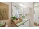 Well-lit bathroom featuring a large mirror, vanity with storage, and stylish decor at 310 S Delaware Ave # F, Tampa, FL 33606