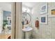 Stylish powder room with attractive wallpaper, a pedestal sink, and nearby office space at 310 S Delaware Ave # F, Tampa, FL 33606