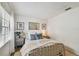 Bright bedroom with neutral tones, a metal bed frame, and natural light from the window at 310 S Delaware Ave # F, Tampa, FL 33606