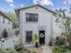 Charming two-story townhouse features a black front door, manicured landscaping, and a well-maintained exterior at 310 S Delaware Ave # F, Tampa, FL 33606
