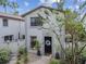 Charming two-story townhouse features a black front door, manicured landscaping, and a well-maintained exterior at 310 S Delaware Ave # F, Tampa, FL 33606
