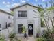 Charming two-story townhouse features a black front door, manicured landscaping, and a well-maintained exterior at 310 S Delaware Ave # F, Tampa, FL 33606