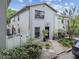 Charming two-story townhouse features a black front door, manicured landscaping, and a well-maintained exterior at 310 S Delaware Ave # F, Tampa, FL 33606