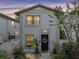 Charming townhouse featuring a black front door, front garden, and welcoming curb appeal at sunset at 310 S Delaware Ave # F, Tampa, FL 33606
