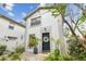 Lovely townhome featuring a black front door, a decorative wreath, and neat landscaping, enhancing curb appeal at 310 S Delaware Ave # F, Tampa, FL 33606