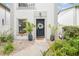 Attractive front entrance with a black door, wreath, and potted plants lining the walkway, inviting curb appeal at 310 S Delaware Ave # F, Tampa, FL 33606