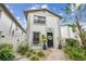 Delightful townhouse boasting a neat garden, black front door and charming curb appeal under a blue sky at 310 S Delaware Ave # F, Tampa, FL 33606