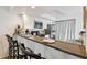 Modern kitchen with sleek countertops, a breakfast bar, stainless appliances, and black barstools at 310 S Delaware Ave # F, Tampa, FL 33606