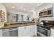 Contemporary kitchen featuring stainless steel appliances, quartz countertops and a view of the living room at 310 S Delaware Ave # F, Tampa, FL 33606