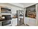 Kitchen features stainless steel appliances, white cabinetry, and a laundry area at 310 S Delaware Ave # F, Tampa, FL 33606