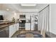 Well-lit kitchen featuring stainless steel appliances, white cabinets, and a vibrant rug at 310 S Delaware Ave # F, Tampa, FL 33606