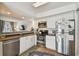 Open kitchen with stainless steel appliances and a view into the nearby living room at 310 S Delaware Ave # F, Tampa, FL 33606