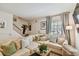 Bright living room featuring a comfortable sectional sofa and large window with natural light at 310 S Delaware Ave # F, Tampa, FL 33606