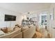 Open-concept living room with a cozy sofa, and view of the kitchen, creating a cohesive and inviting space at 310 S Delaware Ave # F, Tampa, FL 33606