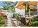 Cozy outdoor patio area with seating, umbrella, BBQ and a privacy fence at 310 S Delaware Ave # F, Tampa, FL 33606