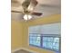 This cozy bedroom features a ceiling fan and a bright window at 330 Promenade Dr # 206, Dunedin, FL 34698