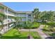 This inviting condo building offers multiple balconies and well-maintained landscaping, creating a welcoming ambiance at 330 Promenade Dr # 206, Dunedin, FL 34698