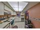 Bright kitchen features tile flooring and countertops, white cabinets, and modern appliances at 330 Promenade Dr # 206, Dunedin, FL 34698