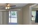 The room features sliding doors to a balcony with a ceiling fan at 330 Promenade Dr # 206, Dunedin, FL 34698