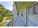 The serene outdoor hallway provides access to apartments, enhanced with picturesque views of palm trees at 330 Promenade Dr # 206, Dunedin, FL 34698